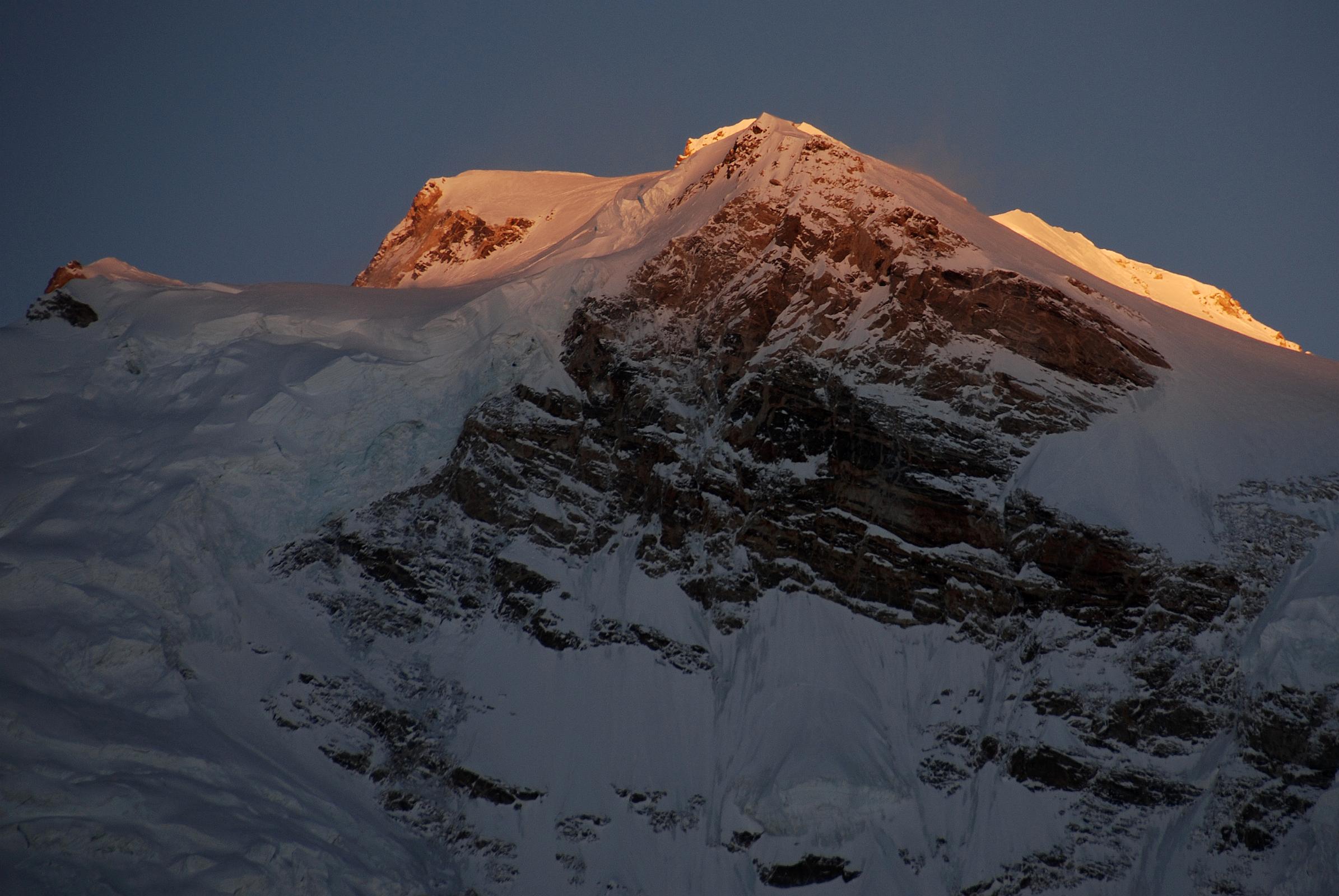 20 First Rays Of Sunrise On Shishapangma Main And East Summits And East Face From Kong Tso The first rays of sunrise silhouette the Shishapangma main summit (8012m) and the central summit on the right with the steep east face from Kong Tso camp (5198m).